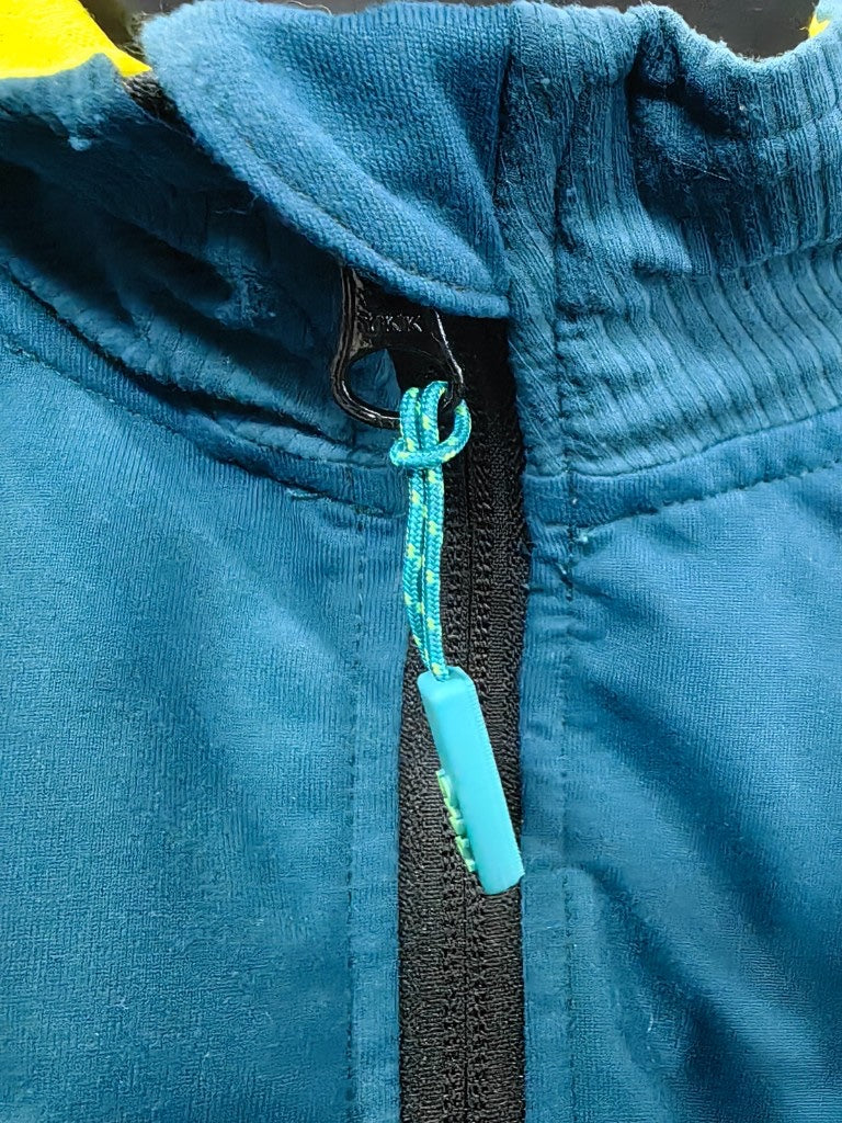 Custom branded plastic zipper puller cord on athletic apparel.
