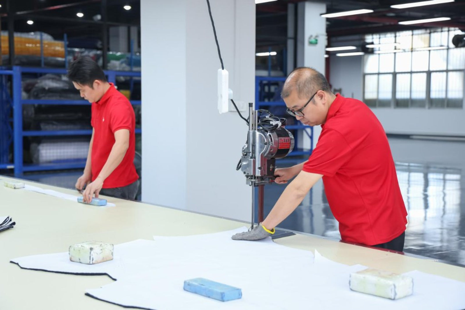 Precision bulk fabric cutting machine and table at TALON factory — TALON OEM manufacturing