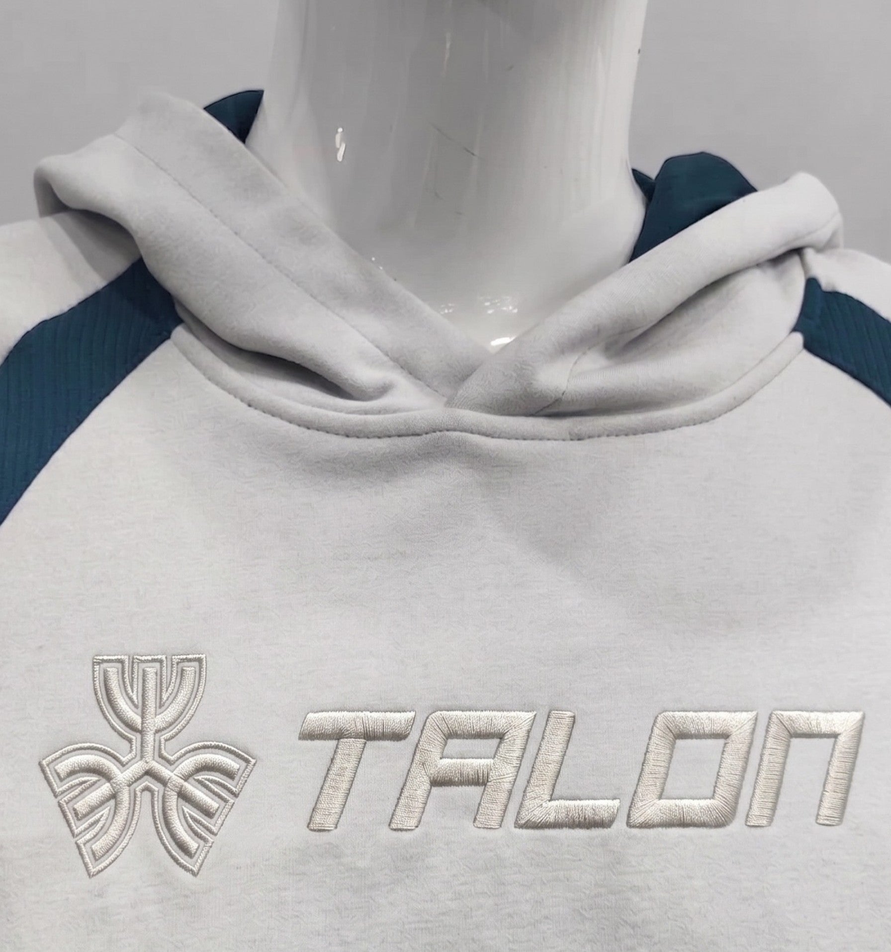 Raised puff 3D embroidery TALON logo on grey hoodie sportswear.