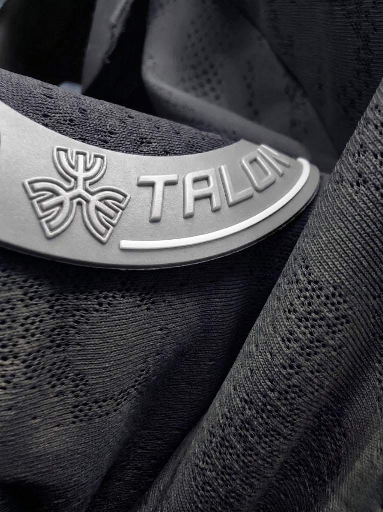 Close-up of a raised, 3D silicone rubber badge on sportswear.