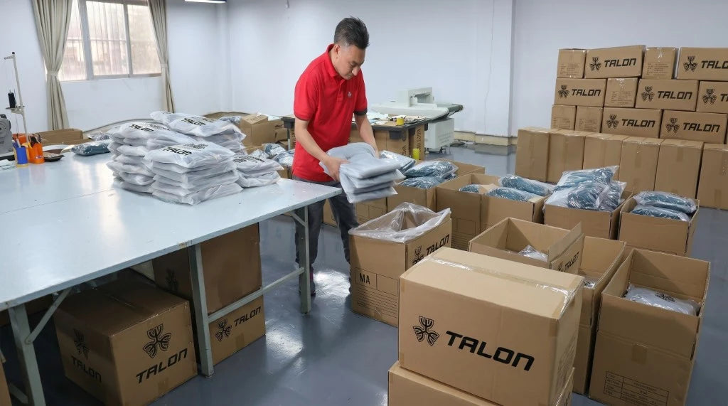 Packing table with folding and inspection at TALON export line — TALON OEM manufacturing