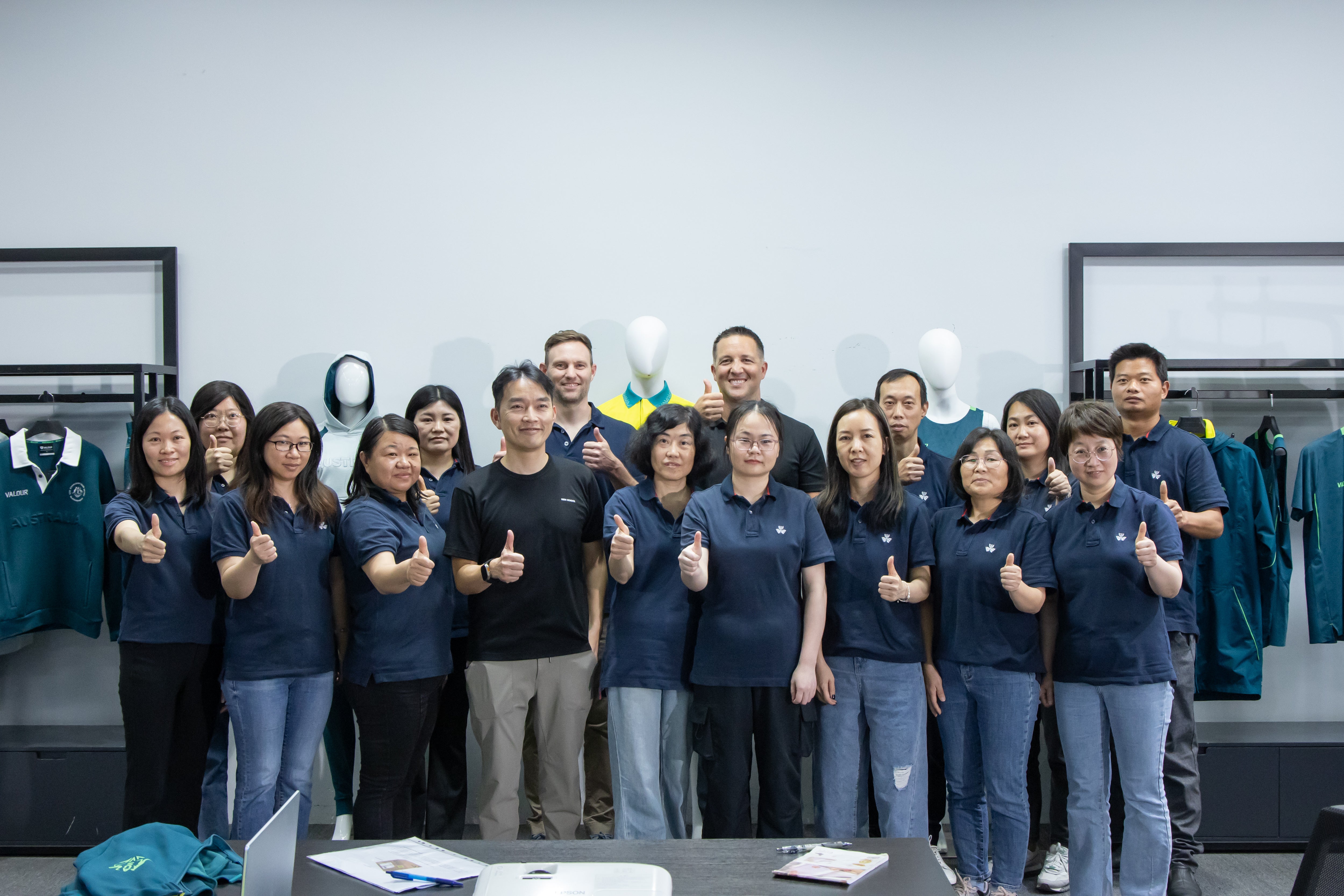 Group of Talon employees giving thumbs up in showroom. — TALON OEM manufacturing