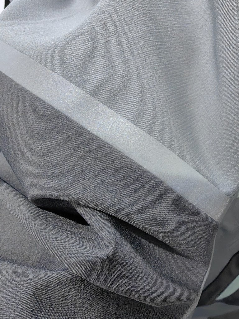 Technical waterproof breathable membrane material with silver lining reflective band.